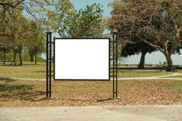 Mock up template: Horizontal billboard out of home (OOH) advertising poster in public park, Display held by iron metal frame design, installed on grass. Trees in background; bright sunny day.