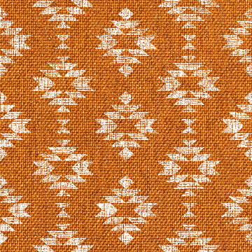Block print Aztec diamonds orange burlap texture seamless pattern, textured tribal Southwestern Aztec geometrics on fabric texture background.