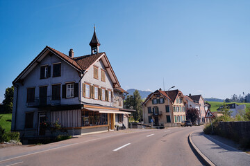 Charming Rural Village Street with Traditional Houses and Bright Daylight..