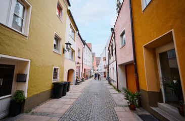 Charming Cobblestone Street with Colorful Houses and Urban Life Scene..