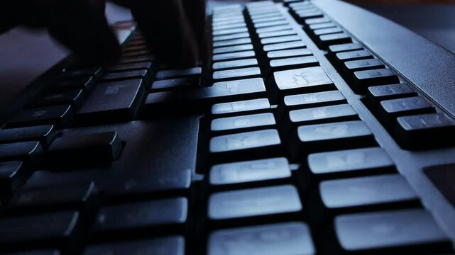 Close-up of person working on computer Man typing something on keyboard. Mailing with someone. Actively pressing keys down of technology device. Network. Web and digital concept.
