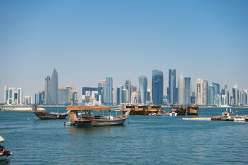 Obraz premium Traditional Dhows and Modern Skyline of Doha, Qatar – Waterfront Cityscape