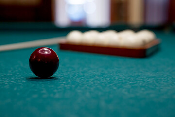 Russian billiards. Red and white balls are lying on a green billiard table. Spending time at home...
