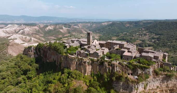 Breathtaking aerial image of Civita di Bagnoregio, an iconic Italian town standing on eroding tuff rock. Town, surrounded by scenic countryside, remains symbol of resilience history.