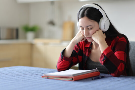 Asian student studying reading notes listening tutorial