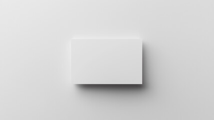 Blank white card on a flat surface, symbolizing simplicity and clarity in design.