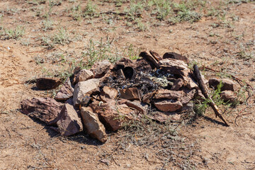 burning organic garbage in a campfire in nature. An extinct campfire in the mountains after tourists