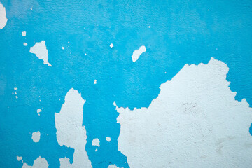 Weathered blue wall with peeling paint, grunge texture ideal for creative design and photography backdrops