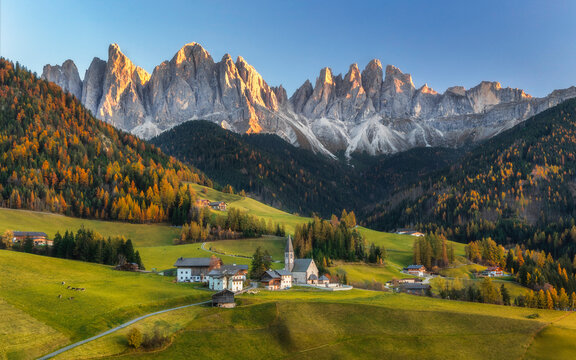 Autumn in Alps. Beautiful St. Magdalena village with magical Dolomites mountains in a gorgeous Val di Funes valley, South Tyrol, Italian Alps at autumn sunset.