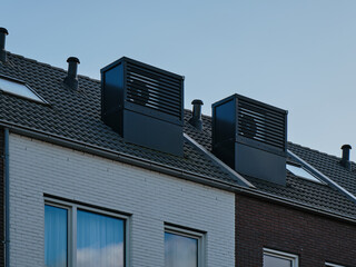 Modern row houses with integrated heat pumps on the roof in Assen