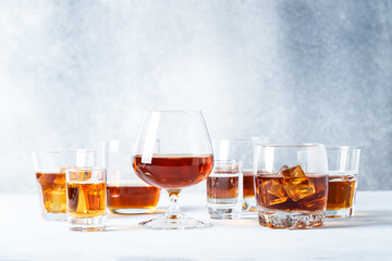 Strong alcohol drink. Cognac, whisky, rum, tequila at light background.