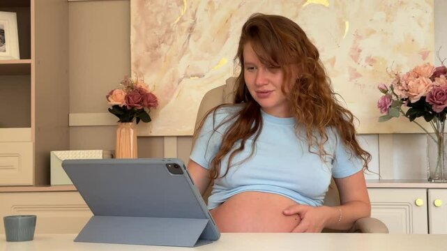 beautiful pregnant woman in her own office working on tablet. businesswoman concept