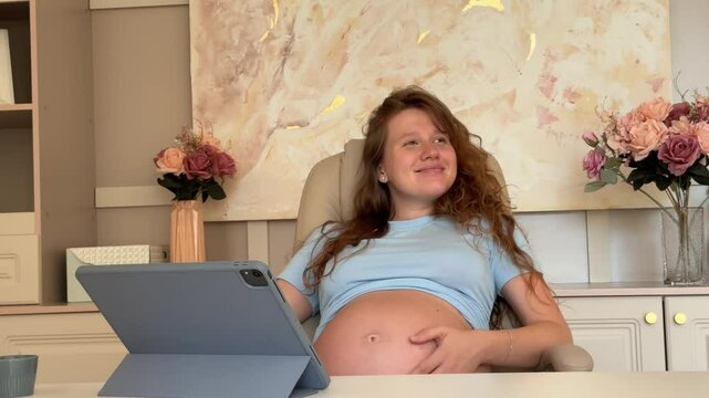 beautiful pregnant woman in her own office working on tablet. businesswoman concept