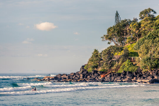 Swimmers in the waves at the beach.