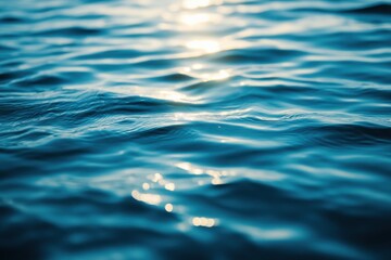 Fototapeta premium Serene expanse of blue ocean water reflecting sunlight creating a calming and tranquil atmosphere with gentle ripples and waves