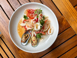 Thai spicy salad with lettuce, shrimps, mussels and squid