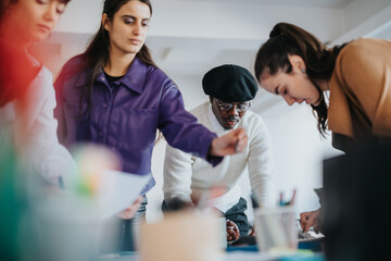 A group of professionals engaging in teamwork and strategic discussions in an office setting.