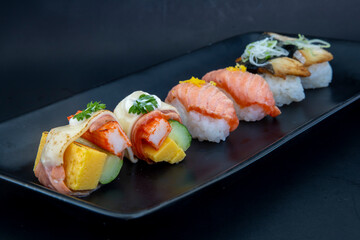Selection of Japanese nigiri sushi on black plate