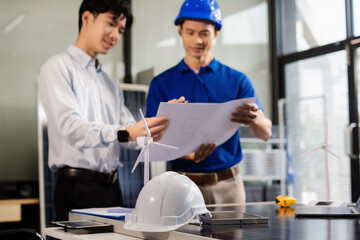 Two colleagues discussing data working and tablet, laptop with on Construction Site project, Clean energy and solar panel concept.
