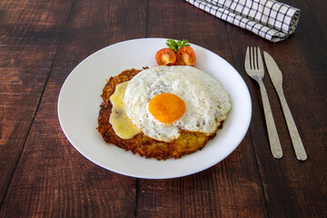 Swiss national dish. Roesti, a potato cake served with Swiss cheese and fried egg.