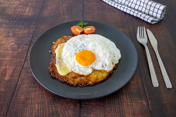 Swiss national dish. Roesti, a potato cake served with Swiss cheese and fried egg.