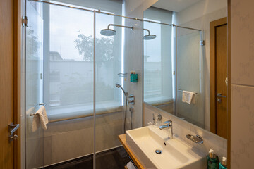Interior of a luxury hotel bathroom with glass shower cabin