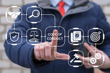 Business person using virtual touch screen push inscription: CODE OF CONDUCT. Code of Conduct Business concept. Ethical integrity, value and ethics.