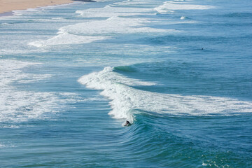 Wide angle of surfers in the blue ocean. Great tricks