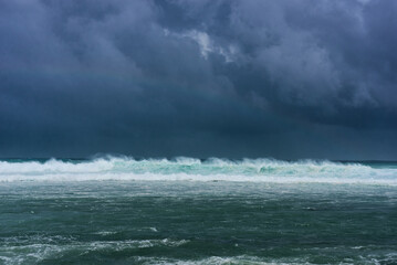 View of powerful high waves crashing in the Indian Ocean during a cyclone in Mauritius, capturing...