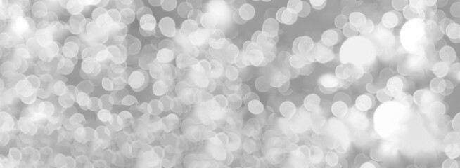 Blurred background silver glitter shiny sparkling banner. Happy Holidays background for white template on christmas card brochure. Silver bokeh template for digital presentation slideshow background
