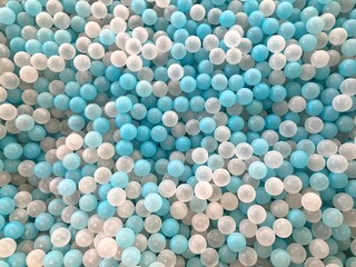 full frame collection of blue and white plastic ball toys for children's ball pools in indoor children's play areas, can be used for wallpaper or background