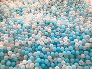 full frame collection of blue and white plastic ball toys for children's ball pools in indoor children's play areas, can be used for wallpaper or background