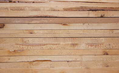 Tightly stacked boards, a stack of boards in a pile
