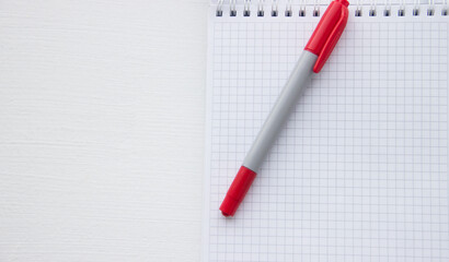 Checkered notebook with red marker
