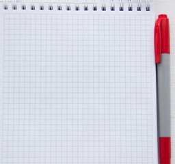 Checkered notebook with red marker