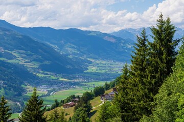 Mountain landscape of Austria. Beautiful view of mountains and meadows with lush green grass.