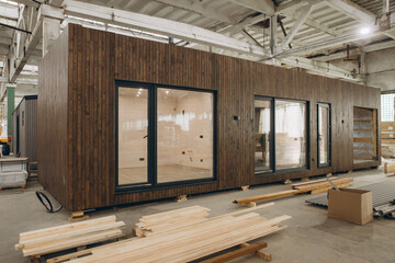 Modular wooden house under construction in a large factory