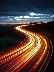 Dynamic light trails illuminate a winding road under a dramatic sky creating a sense of motion and speed in the evening landscape photography