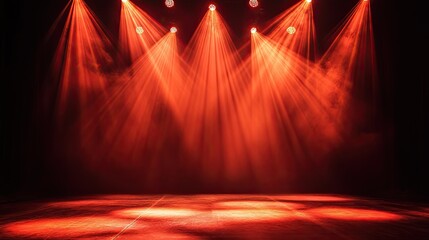 Red and orange dramatic lighting effect creating a high-energy rock concert atmosphere on an empty stage.