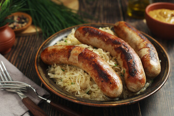A bowl with Bratwurst and Sauerkraut as side dish - traditional German food
