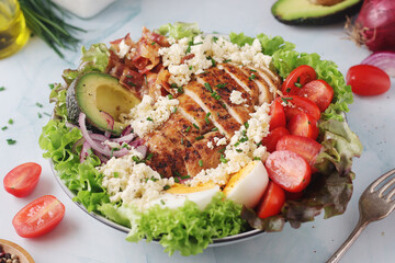 A bowl with cobb salad, traditional American dish