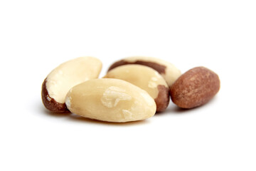 A small cluster of Brazil nuts showcasing smooth, creamy surfaces and natural brown patches, arranged on a white background for a close-up view