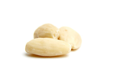 Three smooth blanched almonds arranged on a white background, highlighting their creamy texture and...