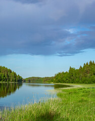 Lake with a cloudy sky in the background