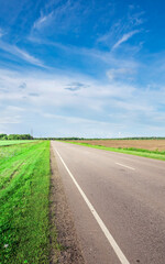 Long, empty road with a blue sky in the background