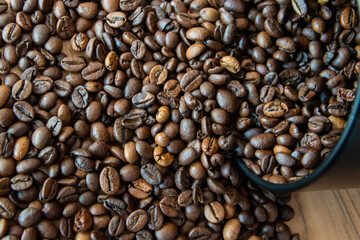 Box with coffe on the roasted coffe beans.