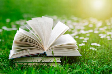 Open Book Nature on Spring Flowers Background. Spring is Coming. Reading Book Relax Break on...