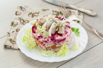 Delicious beetroot salad with herring on a served table