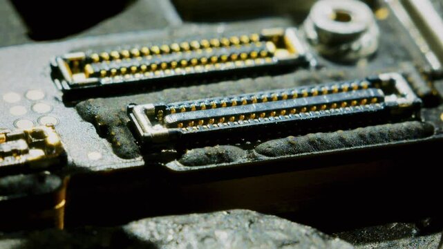 Macro shot of drying paste residue on a CPU microchip. The shot captures the fine details of the microchip and the drying process of the paste. Static shot highlighting the process. 4k, 30 fps.