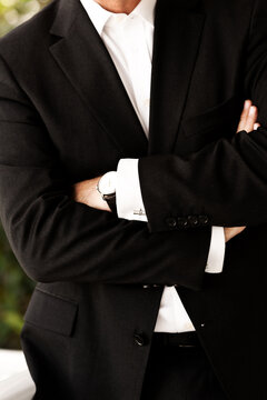 Business man in suit with arms folded